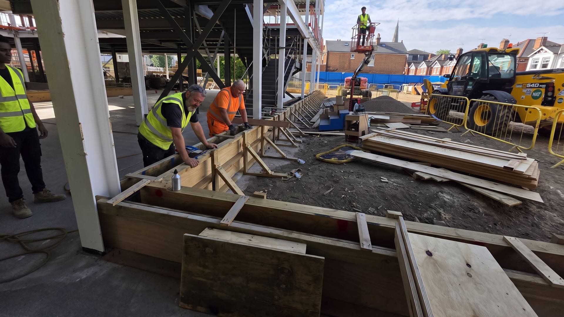 Site team at the formwork under a new steel frame